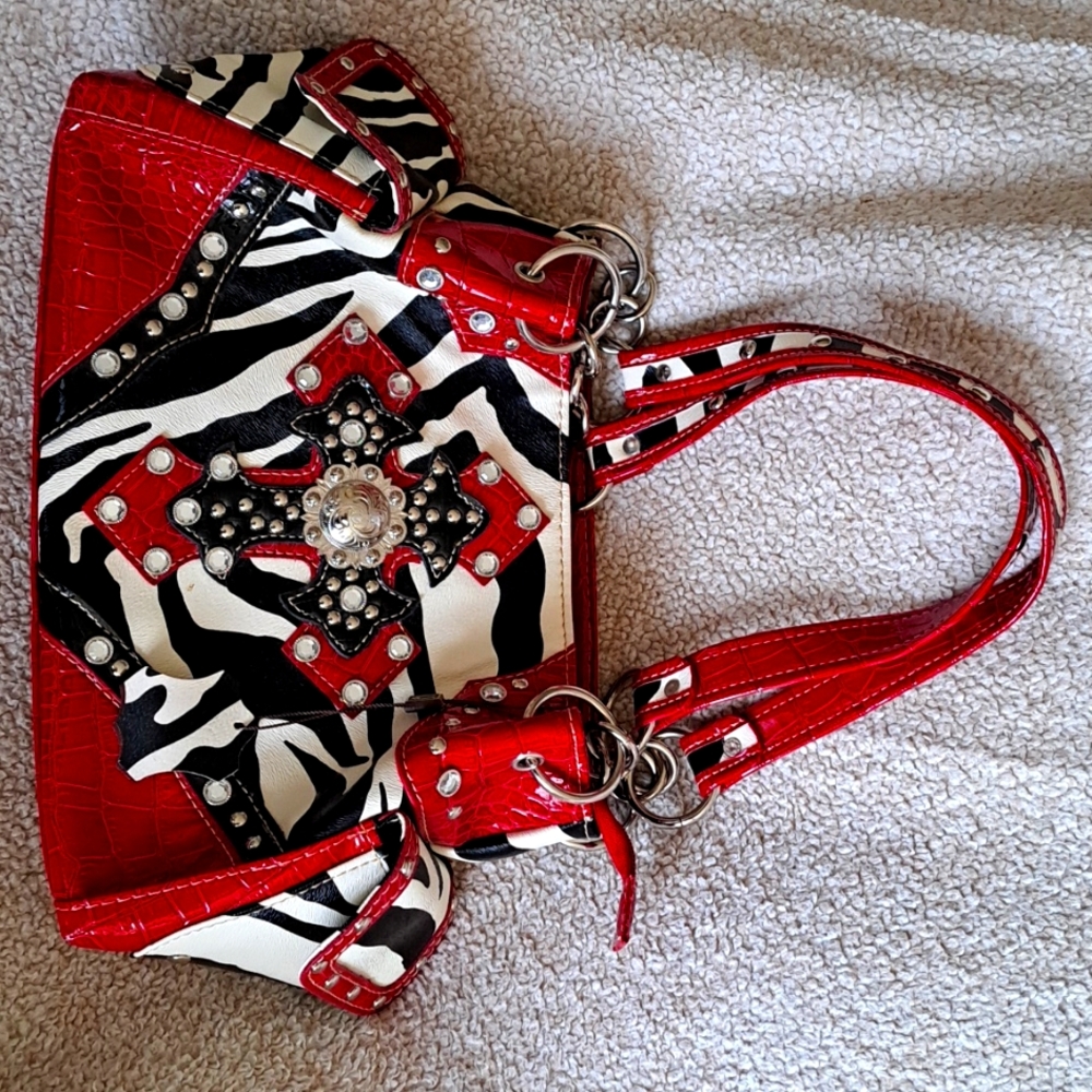 Zebra print zinyl purse with a bejeweled cross. Red, black & white, brown inside